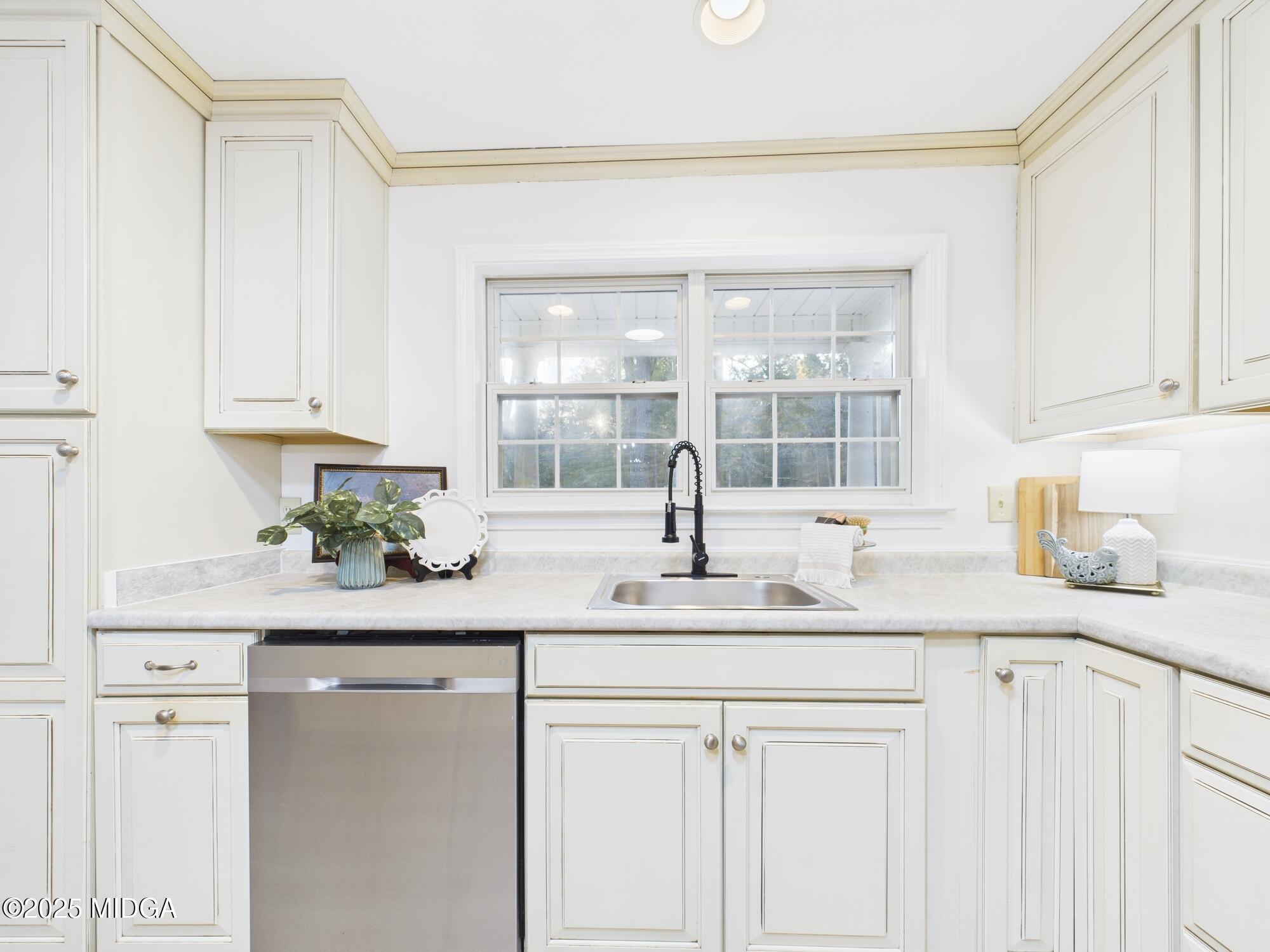 331 Marjane Drive Macon, GA 31210 - Photo 15 of 43 a kitchen with granite countertop white cabinets and white appliances