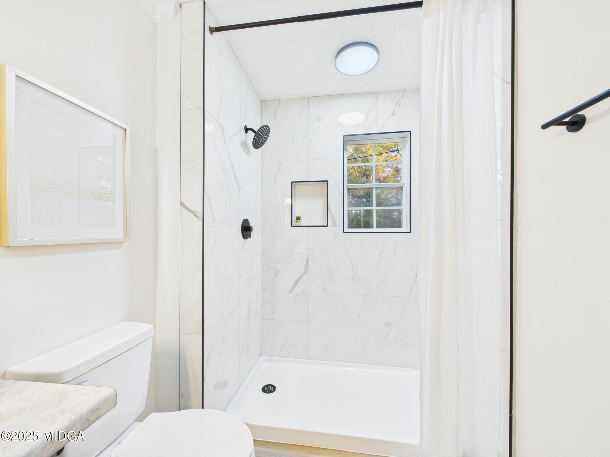 331 Marjane Drive Macon, GA 31210 - Photo 30 of 43 a bathroom with a toilet and a shower
