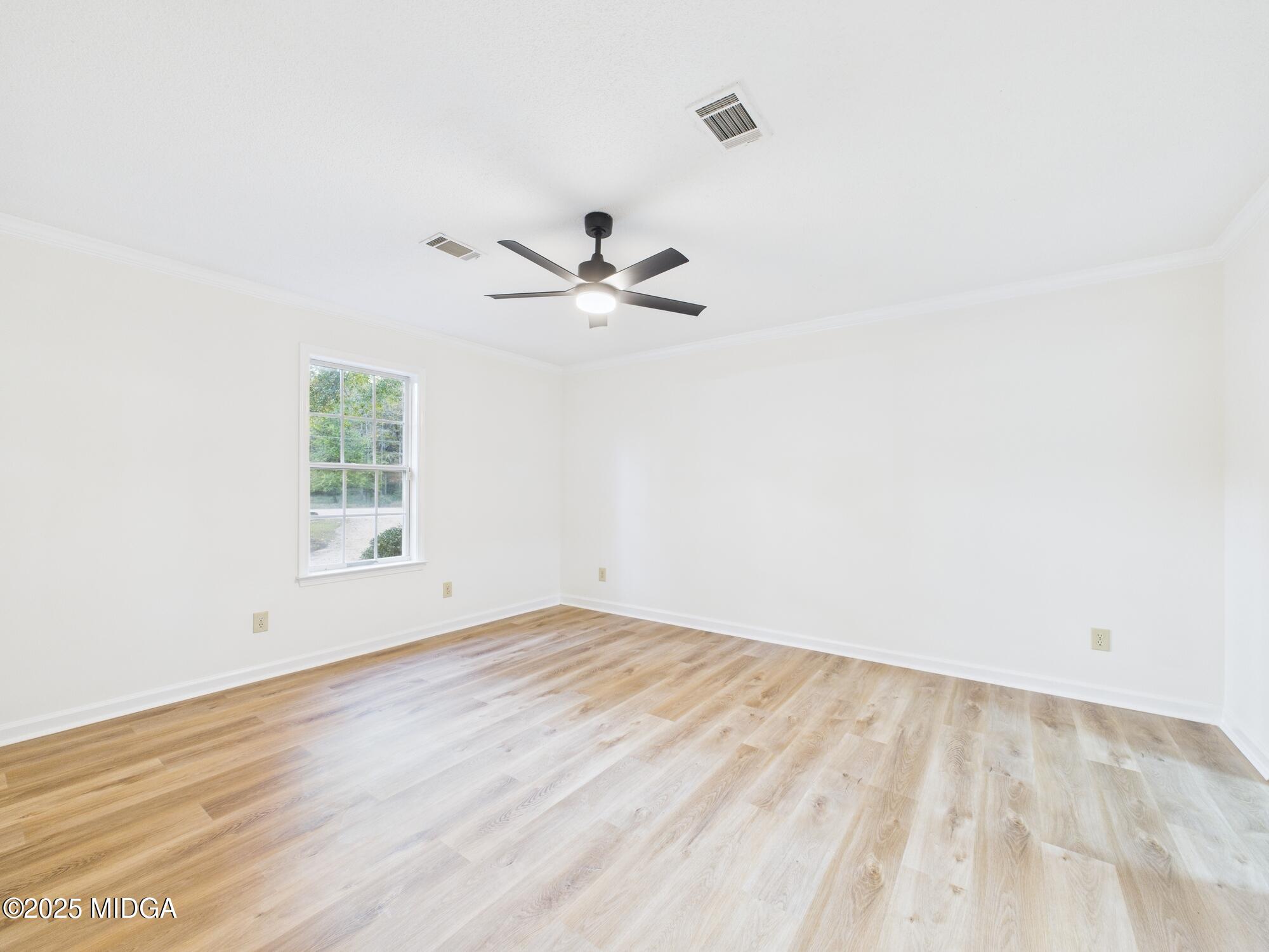 331 Marjane Drive Macon, GA 31210 - Photo 33 of 43 an empty room with wooden floor fan and windows