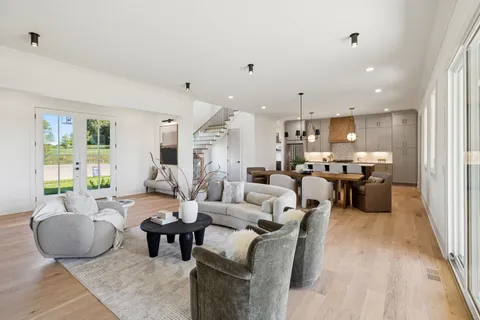 a kitchen with stainless steel appliances a sink a stove and a wooden floors