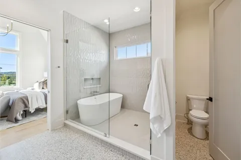 a view of a livingroom with a ceiling fan & a window