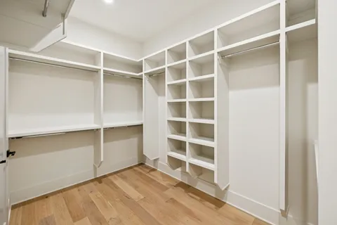 a view of a roof deck with couches and wooden fence