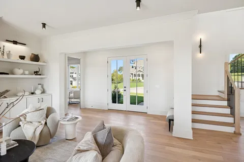 a living room with furniture a table and a large window