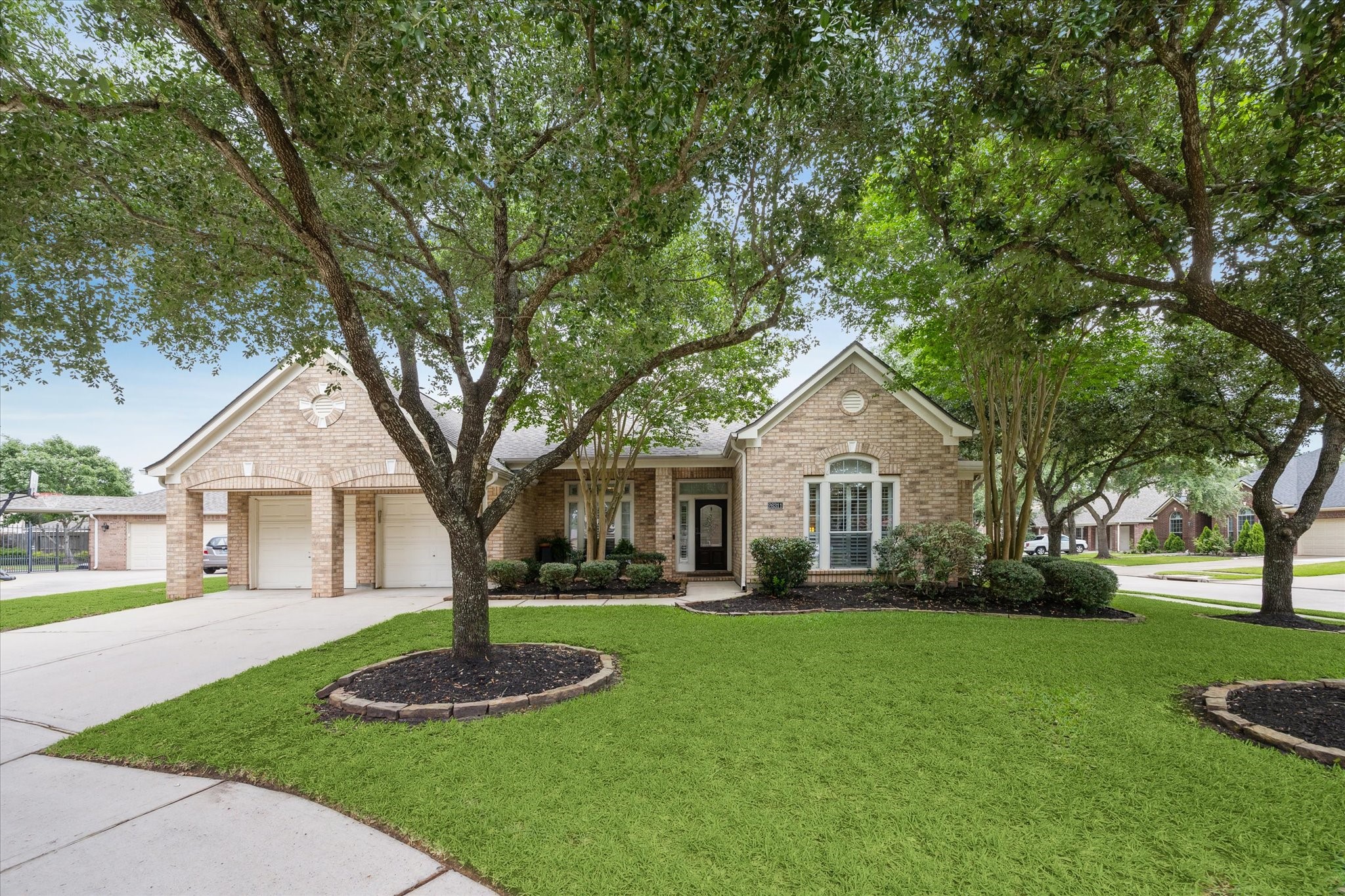 a front view of a house with a yard and trees