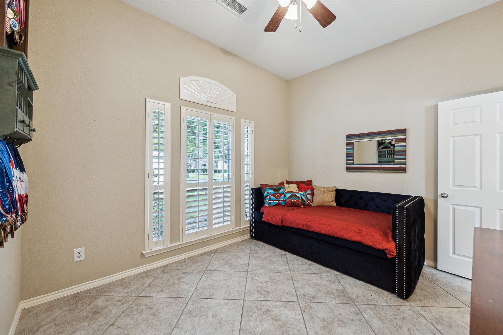 26311 Shady Walk Lane Katy, TX 77494 - Photo 19 of 25 a bedroom with a bed and a chandelier