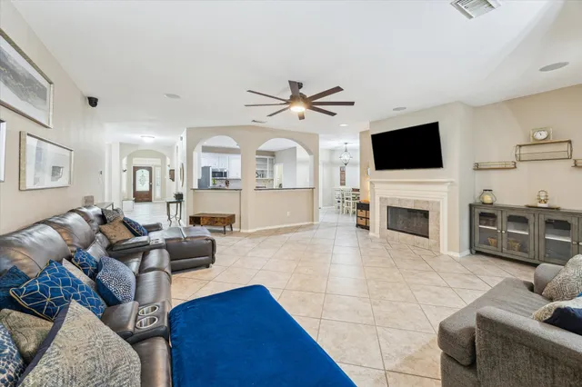 a living room with furniture a fireplace and a flat screen tv