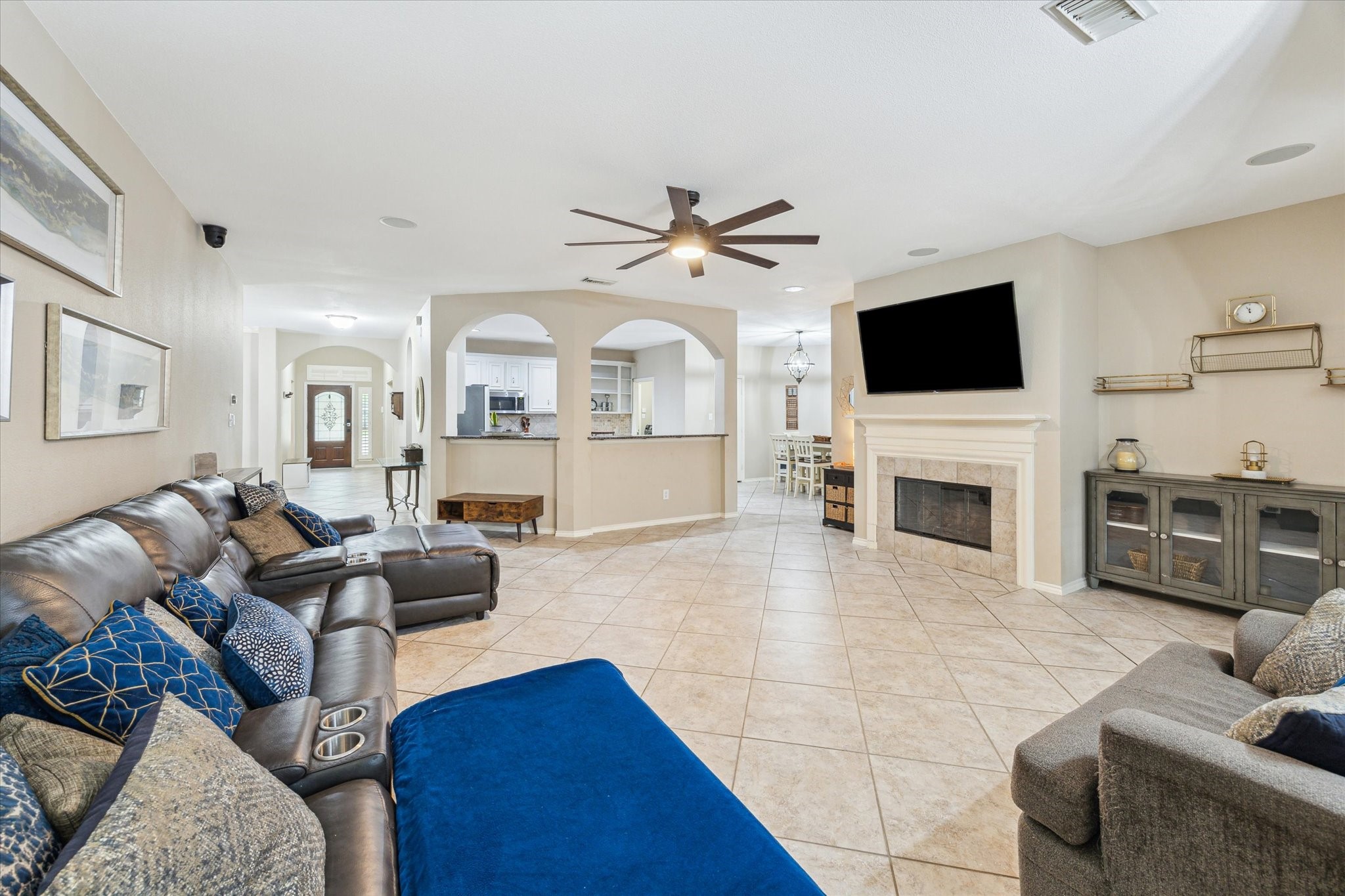 26311 Shady Walk Lane Katy, TX 77494 - Photo 7 of 25 a living room with furniture a fireplace and a flat screen tv