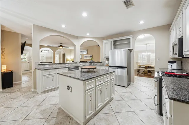 a kitchen with stainless steel appliances granite countertop a sink and cabinets