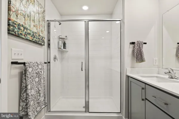 a bathroom with a shower sink and mirror