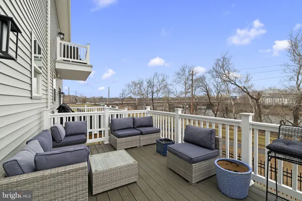 a roof deck with couches and potted plants