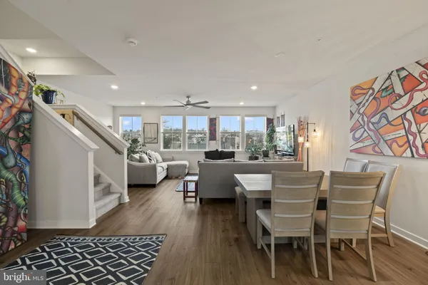 a dining room with furniture and wooden floor
