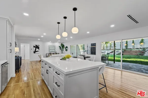 a view of kitchen island with furniture and wooden floor