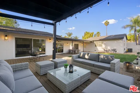 a view of a patio with couches and a potted plant