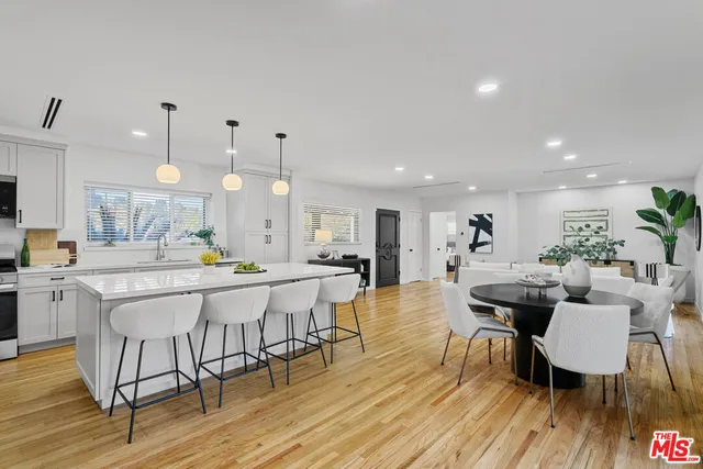 a large kitchen with a table and chairs
