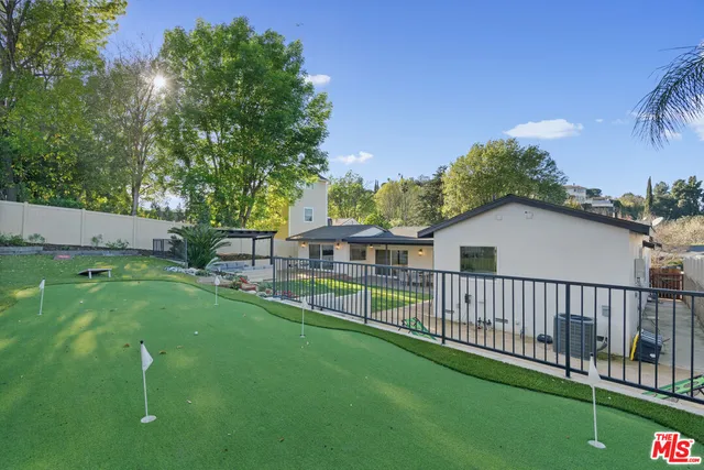 a view of a house with a yard and deck