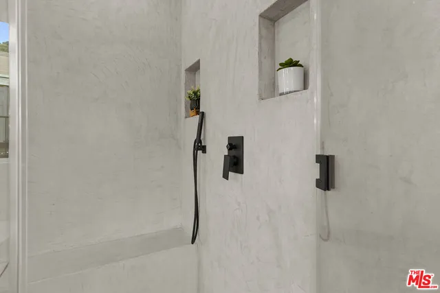 a spacious bathroom with a double vanity sink a mirror and a shower