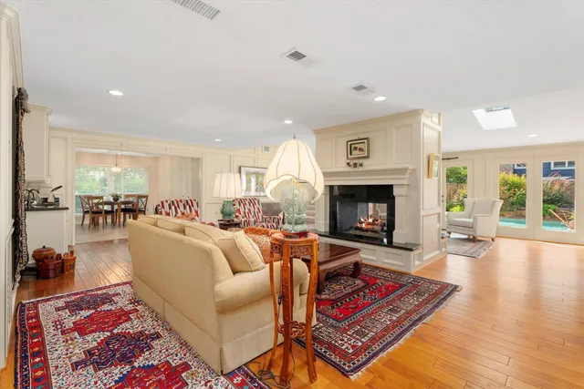 a living room with furniture a fireplace and a table