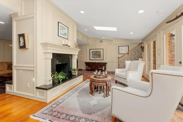a living room with furniture a fireplace and a table