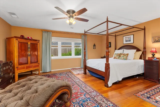 a bedroom with a bed a window and dresser