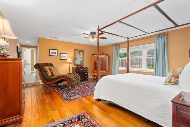 a bed sitting in a bedroom next to a window