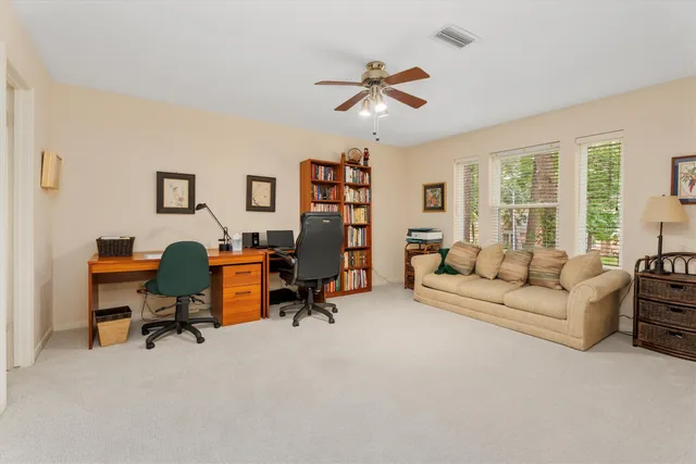 a view of a livingroom with workspace and a couch