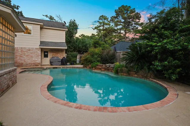 a view of a swimming pool with a yard