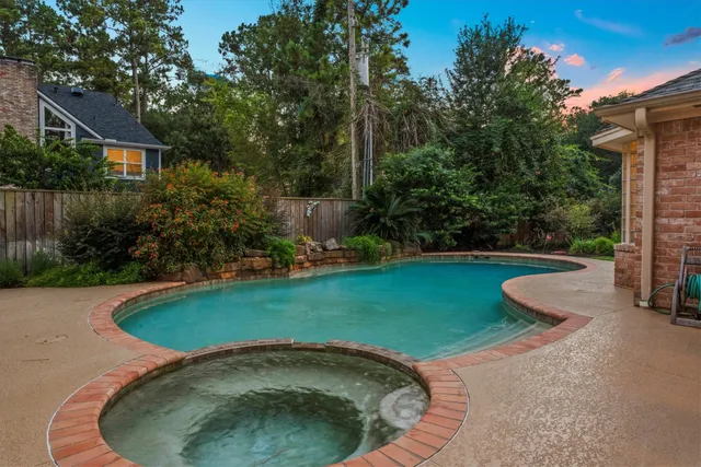 a swimming pool with outdoor seating and garden