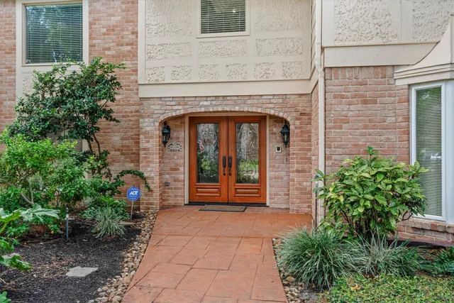 a front view of a house with plants