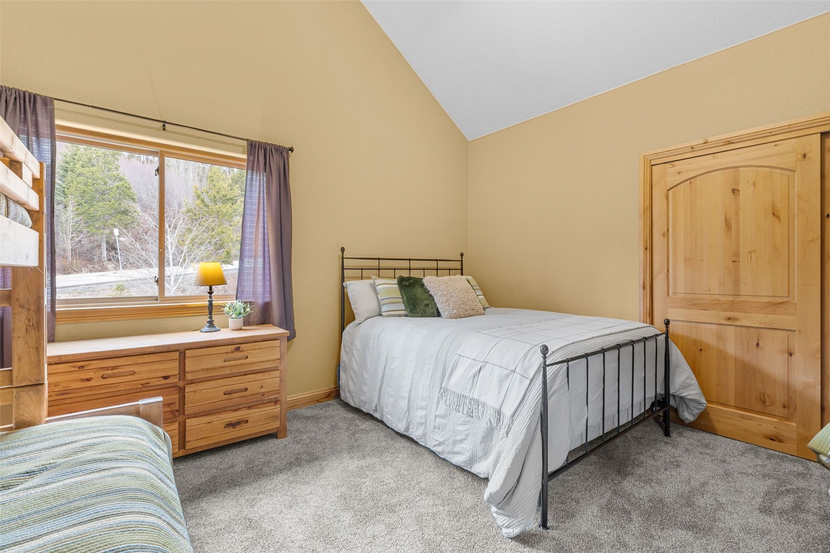 91795 Ryan Gulch Road Silverthorne, CO 80498 - Photo 35 of 50 a bedroom with a bed and wooden floor
