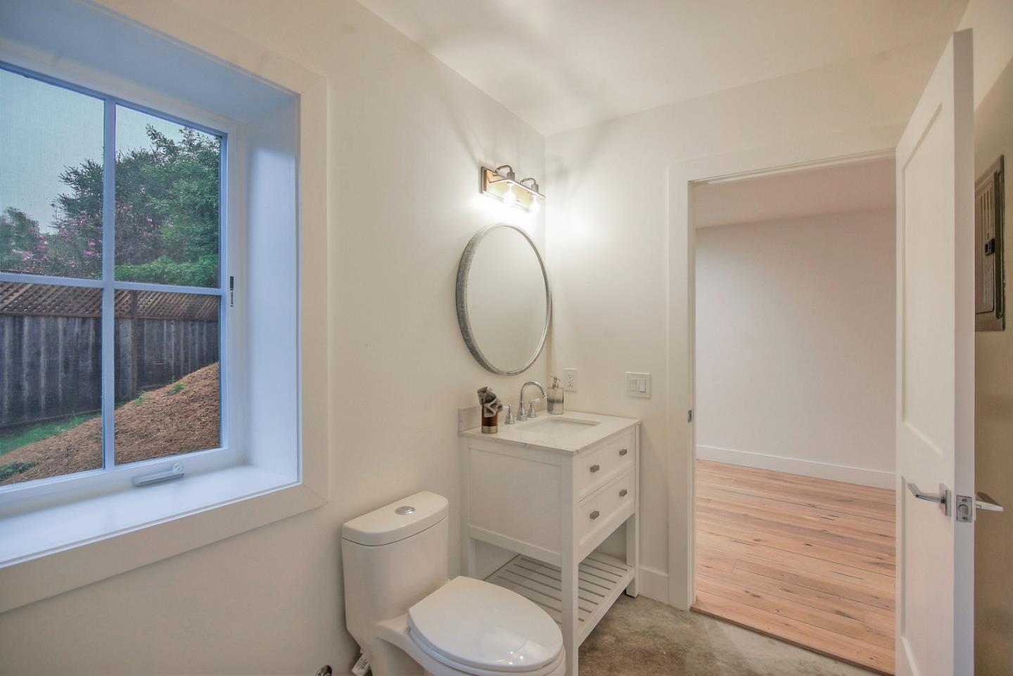 8 Ridge Lane Santa Cruz, CA 95060 - Photo 26 of 29 a bathroom with a toilet sink and mirror