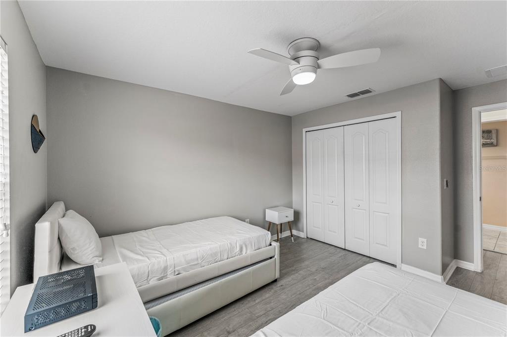 8955 Bismarck Palm Road Kissimmee, FL 34747 - Photo 19 of 32 a bedroom with a bed and a chandelier