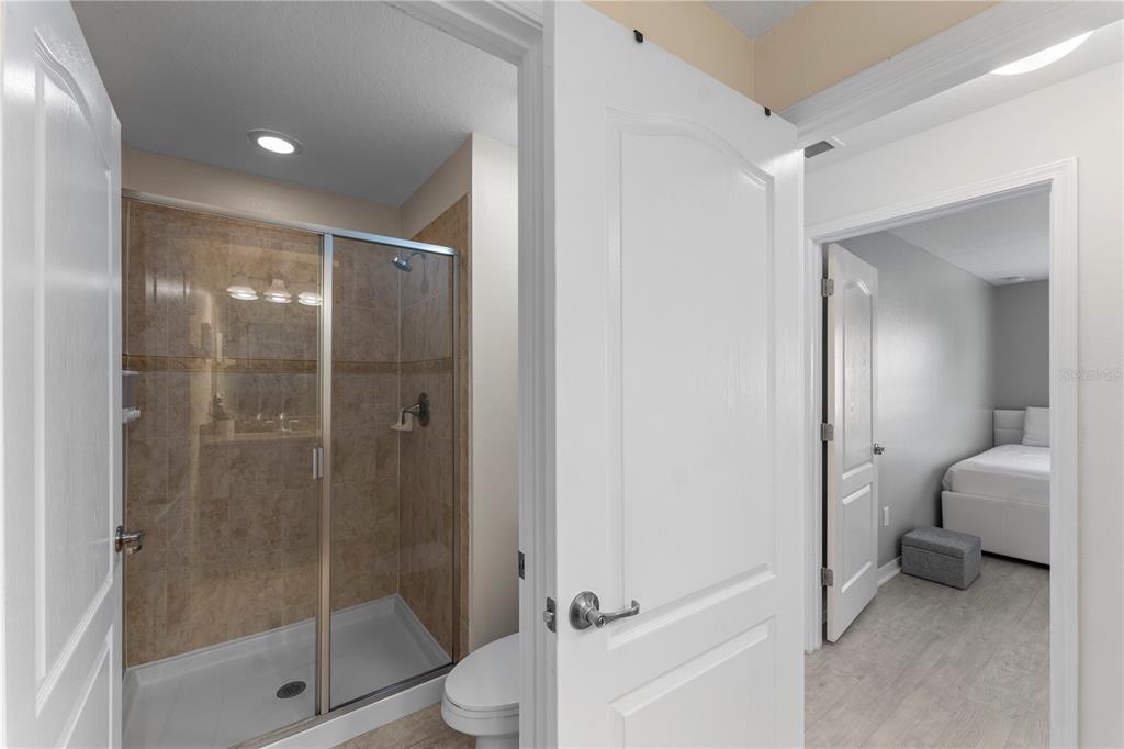 8955 Bismarck Palm Road Kissimmee, FL 34747 - Photo 21 of 32 a bathroom with a shower a toilet and a sink