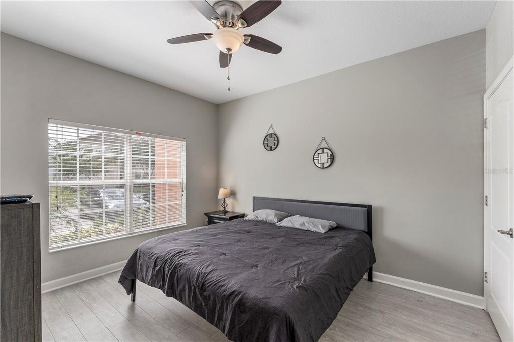 8955 Bismarck Palm Road Kissimmee, FL 34747 - Photo 5 of 32 a bedroom with a large bed and a large window