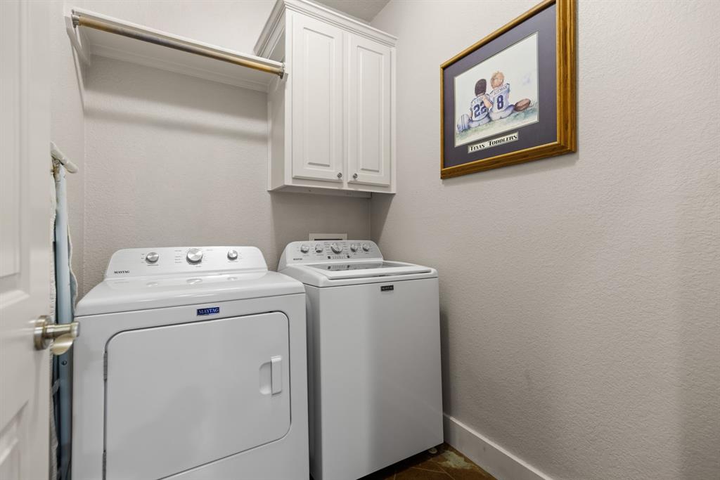 10609 Aquilla Trail Waco, TX 76708 - Photo 30 of 30 Dedicated laundry area featuring textured walls, a built-in hanging rod, and upper cabinetry