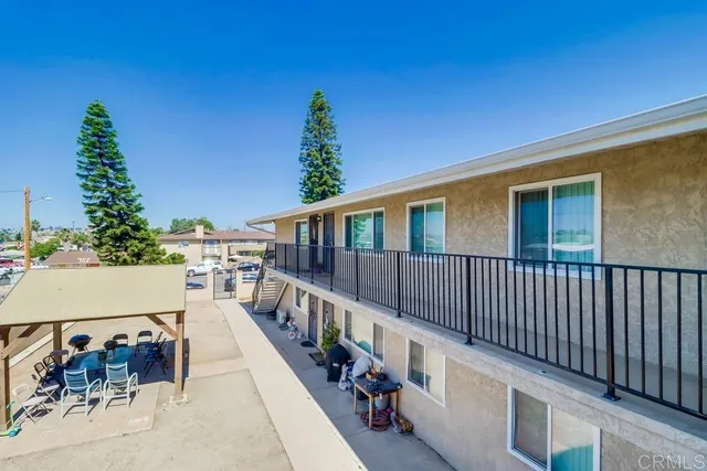 a view of a house with wooden deck