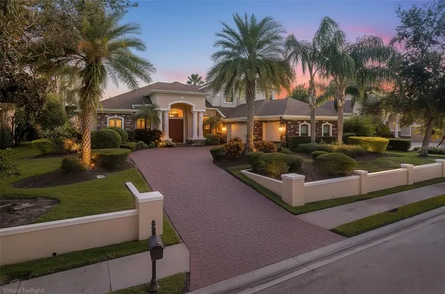 a front view of a house with a yard and potted plants