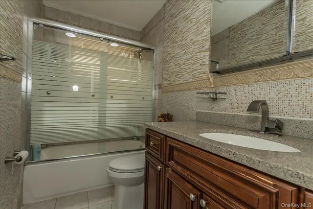 a bedroom with a bed couch and window