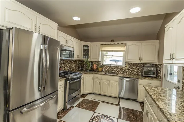 a kitchen with a refrigerator sink and microwave