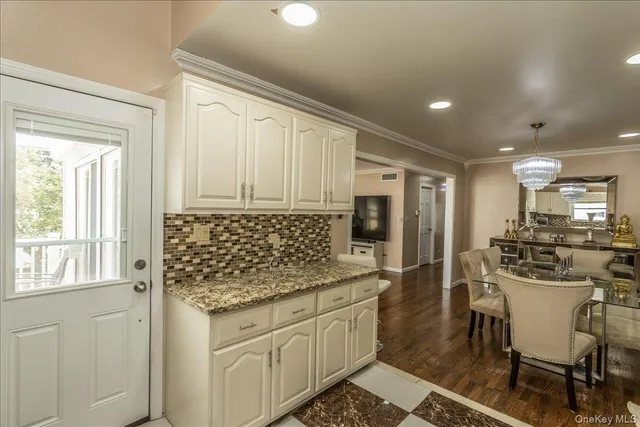 a bedroom with a bed and a flat tv screen on the dresser