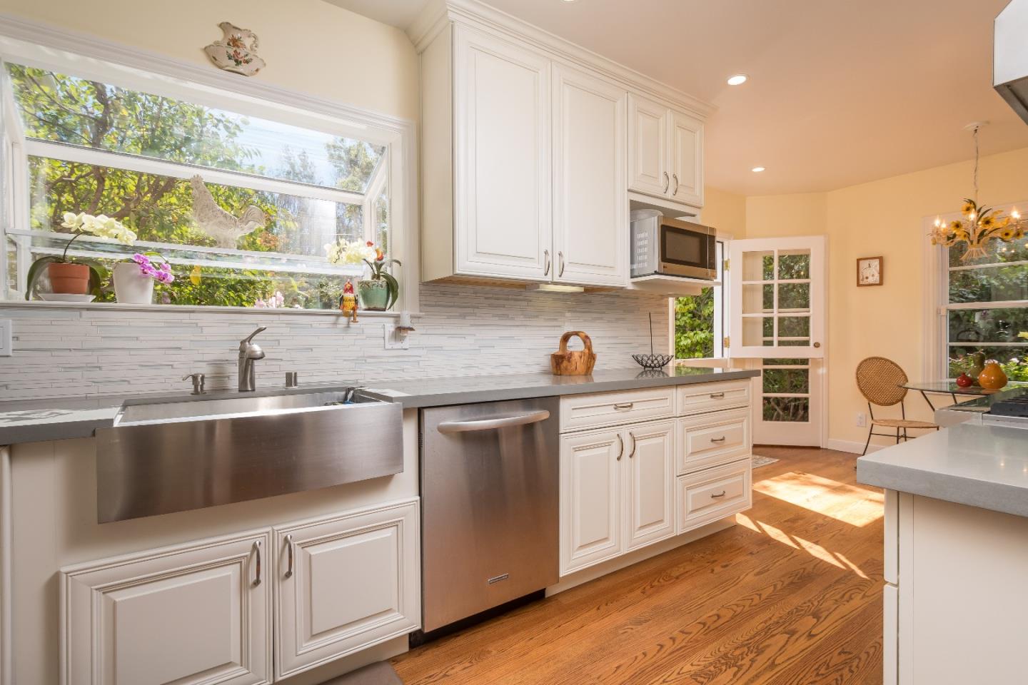 625 Parrott Drive San Mateo, CA 94402 - Photo 9 of 22 a kitchen with granite countertop a sink and white cabinets