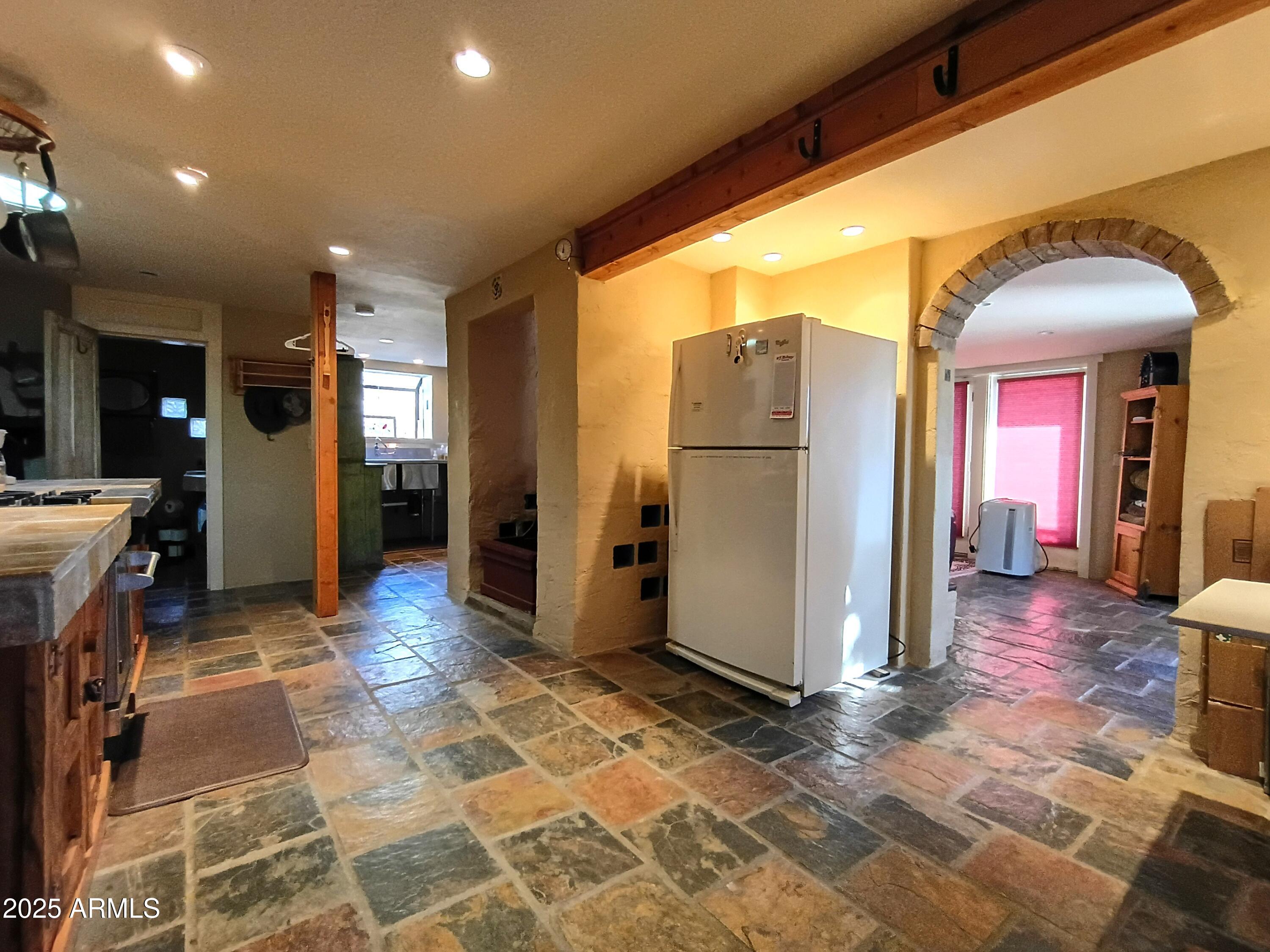 2985 North Federal Mines Road Dewey, AZ 86327 - Photo 11 of 30 a view of a hallway with dining area and chandelier