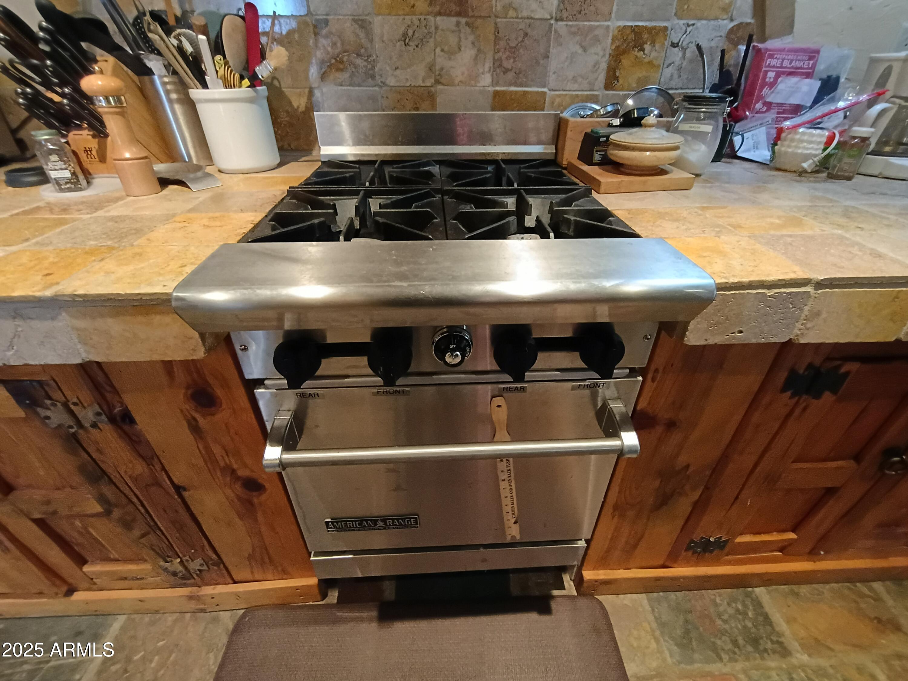 2985 North Federal Mines Road Dewey, AZ 86327 - Photo 13 of 30 a stove top oven sitting inside of a kitchen