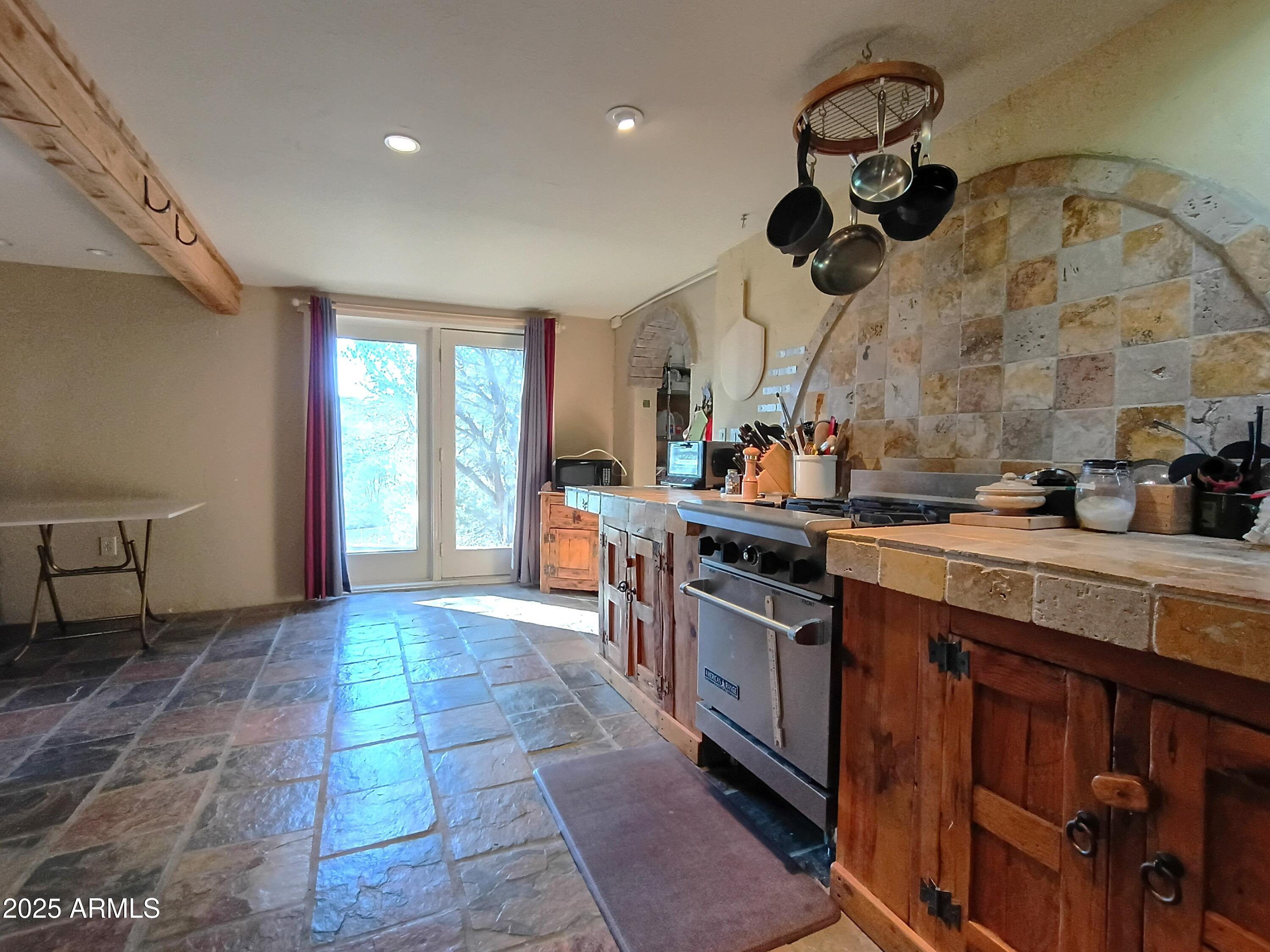 2985 North Federal Mines Road Dewey, AZ 86327 - Photo 14 of 30 a kitchen with stainless steel appliances granite countertop a sink a stove top oven and cabinets