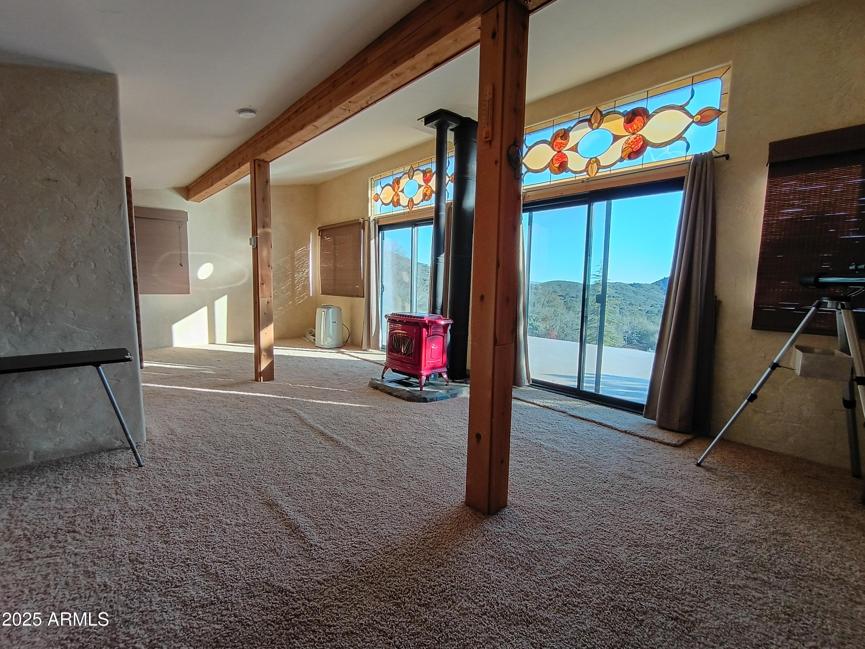 2985 North Federal Mines Road Dewey, AZ 86327 - Photo 20 of 30 a view of an empty room with a floor to ceiling window and a flat screen tv
