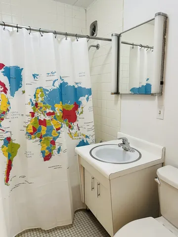 a bathroom with a sink mirror vanity and toilet