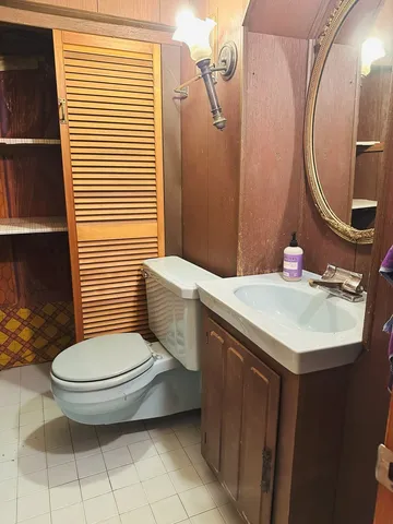 a bathroom with a sink toilet and mirror