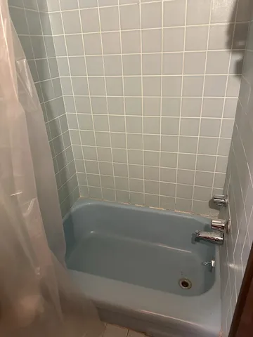 a close up of a bathtub in a bathroom