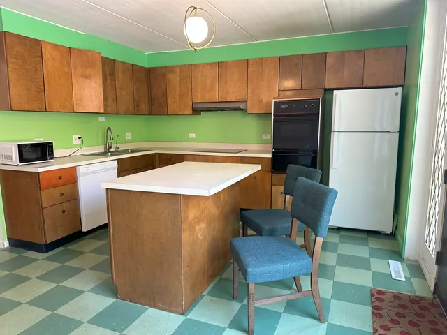 a room with cabinets and a refrigerator