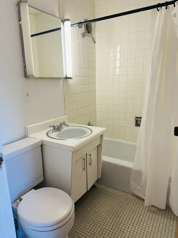 a bathroom with a sink a mirror toilet and bathtub