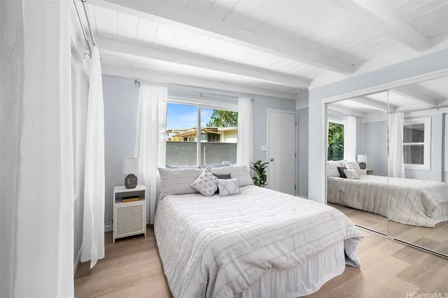 a bedroom with a bed and large window